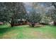 Exterior view of the backyard with a well-maintained lawn, patio area, and mature trees providing privacy and shade at 4144 Hideaway Dr, Tucker, GA 30084