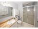A well-lit bathroom featuring a vanity, toilet, and a shower with sliding glass doors at 4144 Hideaway Dr, Tucker, GA 30084