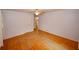 An empty bedroom offers neutral colors, a ceiling fan, hardwood floors, and bright natural light at 4144 Hideaway Dr, Tucker, GA 30084