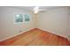 Bright bedroom featuring hardwood floors, neutral walls, natural light, and ceiling fan at 4144 Hideaway Dr, Tucker, GA 30084