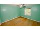 Cozy bedroom with hardwood floors, a ceiling fan, and natural light from the window at 4144 Hideaway Dr, Tucker, GA 30084
