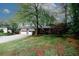 Charming two-story home features a brick facade, attached two-car garage and a well-manicured front lawn with mature trees at 4144 Hideaway Dr, Tucker, GA 30084