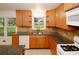 Bright kitchen with stainless sink, wood cabinetry, granite countertops, and natural light from the windows at 4144 Hideaway Dr, Tucker, GA 30084