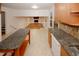 Spacious kitchen featuring granite countertops, tile backsplash, with an open view to the living room at 4144 Hideaway Dr, Tucker, GA 30084