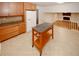 Bright kitchen features tiled floors, wood cabinets, granite countertops, and an island for added prep space at 4144 Hideaway Dr, Tucker, GA 30084