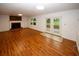 Spacious living room with wood floors, fireplace and French doors provides ample natural light and backyard views at 4144 Hideaway Dr, Tucker, GA 30084