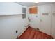 Utility room with shelving, wood floors, and hook for storage at 4144 Hideaway Dr, Tucker, GA 30084