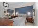 Bedroom featuring a large bed, blue accent wall, and closet with mirrored doors at 855 Peachtree Ne St # 2801, Atlanta, GA 30308