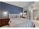 Bedroom with a large bed, blue accent wall, and ensuite bathroom at 855 Peachtree Ne St # 2801, Atlanta, GA 30308