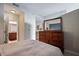 Bedroom featuring a large dresser and ensuite bathroom with granite countertops and wood cabinets at 855 Peachtree Ne St # 2801, Atlanta, GA 30308