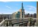High rise balcony view shows outdoor seating and surrounding city skyline during the day at 855 Peachtree Ne St # 2801, Atlanta, GA 30308