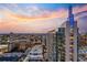 Exterior view of a high rise building at dusk with colorful sunset at 855 Peachtree Ne St # 2801, Atlanta, GA 30308