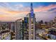 Beautiful exterior of a high rise at dusk with sunset and colorful buildings at 855 Peachtree Ne St # 2801, Atlanta, GA 30308