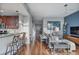 Stylish living room with a breakfast bar, wood floors, and a view of the hallway and the front door at 855 Peachtree Ne St # 2801, Atlanta, GA 30308