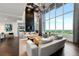 Bright, open living room with floor-to-ceiling windows offering panoramic views and modern furnishings at 855 Peachtree Ne St # 2801, Atlanta, GA 30308