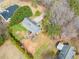 Aerial view of a gray two-story home featuring a spacious backyard with a wooden deck at 113 Emerald Pines Dr, Dallas, GA 30157