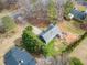 Aerial view of a gray two-story home with a large backyard and deck surrounded by trees at 113 Emerald Pines Dr, Dallas, GA 30157