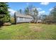 Expansive backyard featuring a wooden deck, lush greenery, and a charming wooden fence at 113 Emerald Pines Dr, Dallas, GA 30157