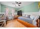 Well-lit bedroom with a daybed, desk, and a ceiling fan, offering a cozy and functional space at 113 Emerald Pines Dr, Dallas, GA 30157