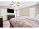 Bedroom with a ceiling fan, two windows, and a TV above a black dresser at 113 Emerald Pines Dr, Dallas, GA 30157