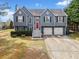 Charming two-story home with gray siding, red front door, and a two-car garage at 113 Emerald Pines Dr, Dallas, GA 30157