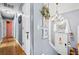 Charming hallway with hardwood floors, elegant lighting, and decorative elements, creating a welcoming entrance at 113 Emerald Pines Dr, Dallas, GA 30157