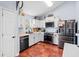 Well-lit kitchen featuring white cabinets, stainless steel appliances, and unique tile flooring at 113 Emerald Pines Dr, Dallas, GA 30157