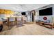 Open concept living space with bar, hardwood floors, ceiling fan, and ample seating, perfect for entertaining at 113 Emerald Pines Dr, Dallas, GA 30157