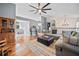 Open living room with hardwood floors, fireplace, and an open view of the dining room at 113 Emerald Pines Dr, Dallas, GA 30157