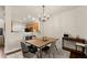 Cozy dining area with a wooden table, comfortable chairs, and view into the kitchen, perfect for Gathering meals at 2427 Millbank Ct, Lawrenceville, GA 30043