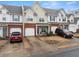 Charming townhome with a brick facade and attached garage, showcasing inviting curb appeal in a residential setting at 2427 Millbank Ct, Lawrenceville, GA 30043