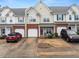 Charming townhome with a brick facade and attached garage, showcasing inviting curb appeal in a residential setting at 2427 Millbank Ct, Lawrenceville, GA 30043