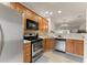 Modern kitchen featuring stainless steel appliances, wooden cabinets, and ample counter space for meal preparation at 2427 Millbank Ct, Lawrenceville, GA 30043
