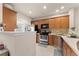 Traditional kitchen with wooden cabinets, stainless steel appliances, and light countertops at 2427 Millbank Ct, Lawrenceville, GA 30043