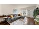 Inviting living room with a comfortable gray sofa, warm lighting, and stylish accents, creating a relaxing atmosphere at 2427 Millbank Ct, Lawrenceville, GA 30043