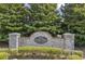 Entrance sign for Little Suwanee Pointe, framed by lush greenery and landscaping at 2427 Millbank Ct, Lawrenceville, GA 30043
