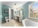 Bathroom with tub, separate toilet, and vanity, offering a blend of functionality and modern design at 917 Edgewater Cir, Marietta, GA 30062