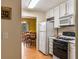 Kitchen with white cabinets and appliances, with a view into the dining room at 917 Edgewater Cir, Marietta, GA 30062