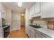 Galley kitchen with white cabinets and modern appliances, offering efficiency and functionality at 917 Edgewater Cir, Marietta, GA 30062