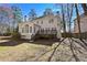View of two-story home from the backyard, with deck and manicured lawn at 1303 Angel Falls Sw Ln, Atlanta, GA 30311