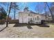 Two-story home with wooden fence and mature trees in the backyard at 1303 Angel Falls Sw Ln, Atlanta, GA 30311