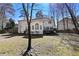 Expansive backyard featuring a sunroom, deck, and mature trees for a private outdoor space at 1303 Angel Falls Sw Ln, Atlanta, GA 30311
