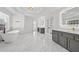 Primary bathroom with double vanities, free standing tub, walk-in shower, and marble floors at 1303 Angel Falls Sw Ln, Atlanta, GA 30311