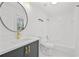 Stylish bathroom featuring modern fixtures, round mirror, custom black cabinets at 1303 Angel Falls Sw Ln, Atlanta, GA 30311