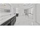 Primary bathroom with double vanities, free standing tub, walk-in shower, and marble floors at 1303 Angel Falls Sw Ln, Atlanta, GA 30311