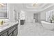 Lavish bathroom features double vanities, freestanding tub, marble tile and open shower at 1303 Angel Falls Sw Ln, Atlanta, GA 30311