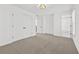 Spacious bedroom with neutral carpet, light fixture, and large double-door closet at 1303 Angel Falls Sw Ln, Atlanta, GA 30311
