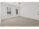 Carpeted bedroom featuring neutral paint, carpet, and double windows for natural light at 1303 Angel Falls Sw Ln, Atlanta, GA 30311