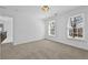 Bright bedroom features neutral carpet, fresh paint, and double windows for natural light at 1303 Angel Falls Sw Ln, Atlanta, GA 30311