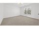 Carpeted bedroom featuring natural light from a large window at 1303 Angel Falls Sw Ln, Atlanta, GA 30311